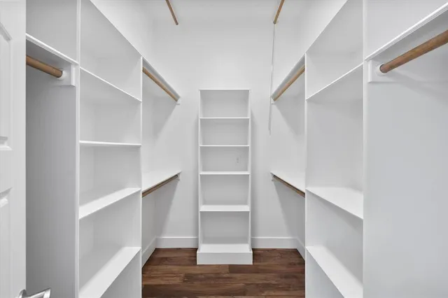 a view of walk in closet with empty racks