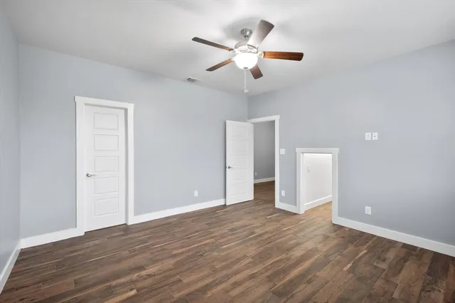a view of an empty room and wooden floor