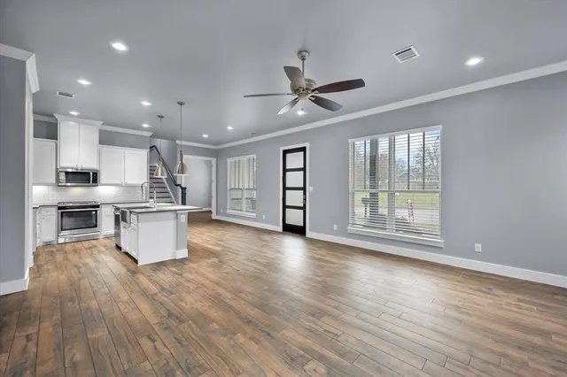 a view of kitchen with furniture and wooden floor