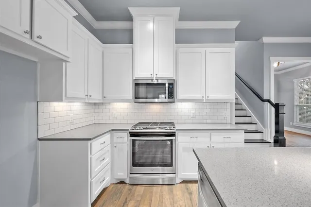 a kitchen with granite countertop a stove and a sink