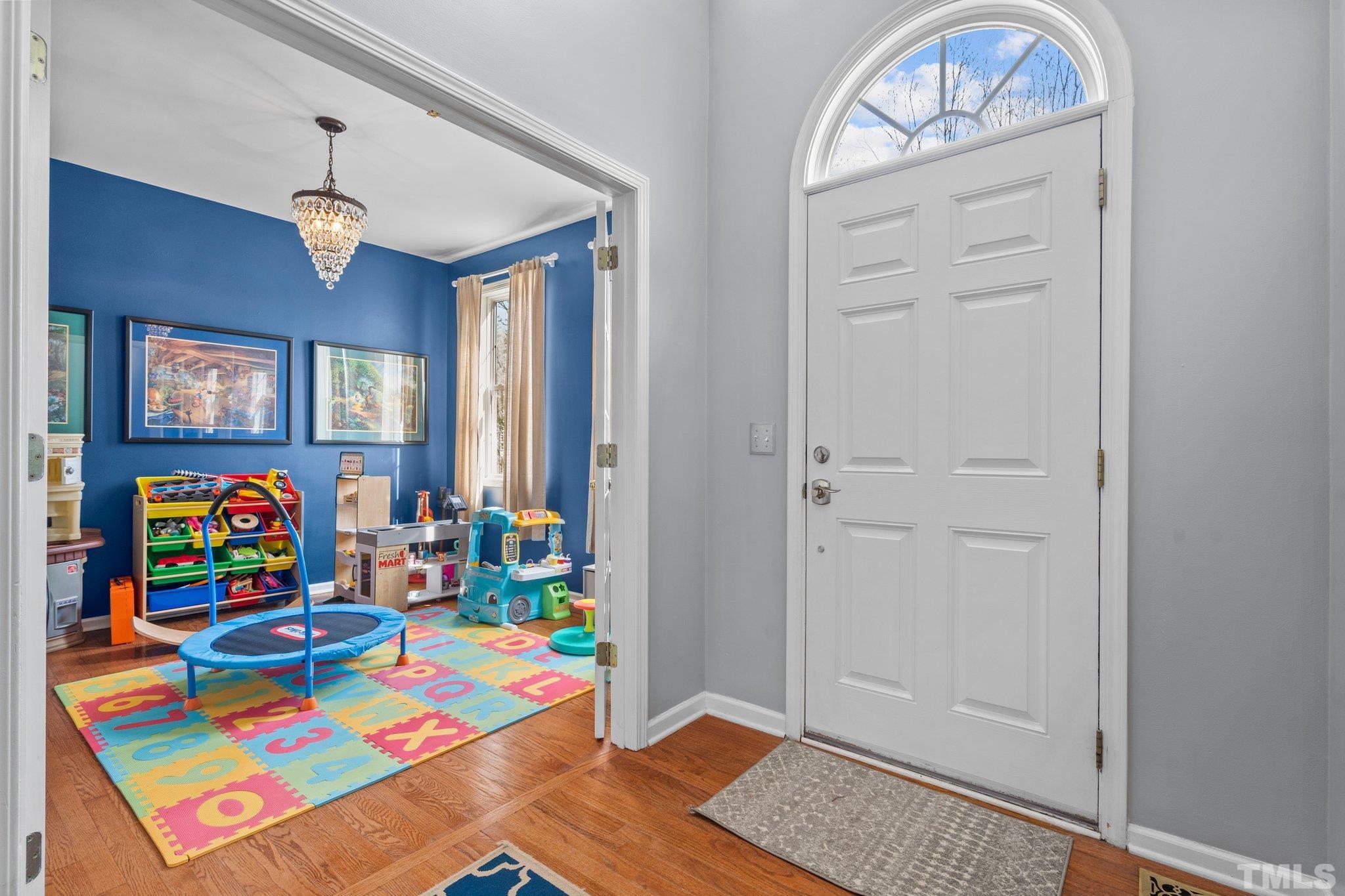 2359 Spruce Shadows Lane Raleigh, NC 27614 - Photo 12 of 34 a living room with furniture and a baby crib