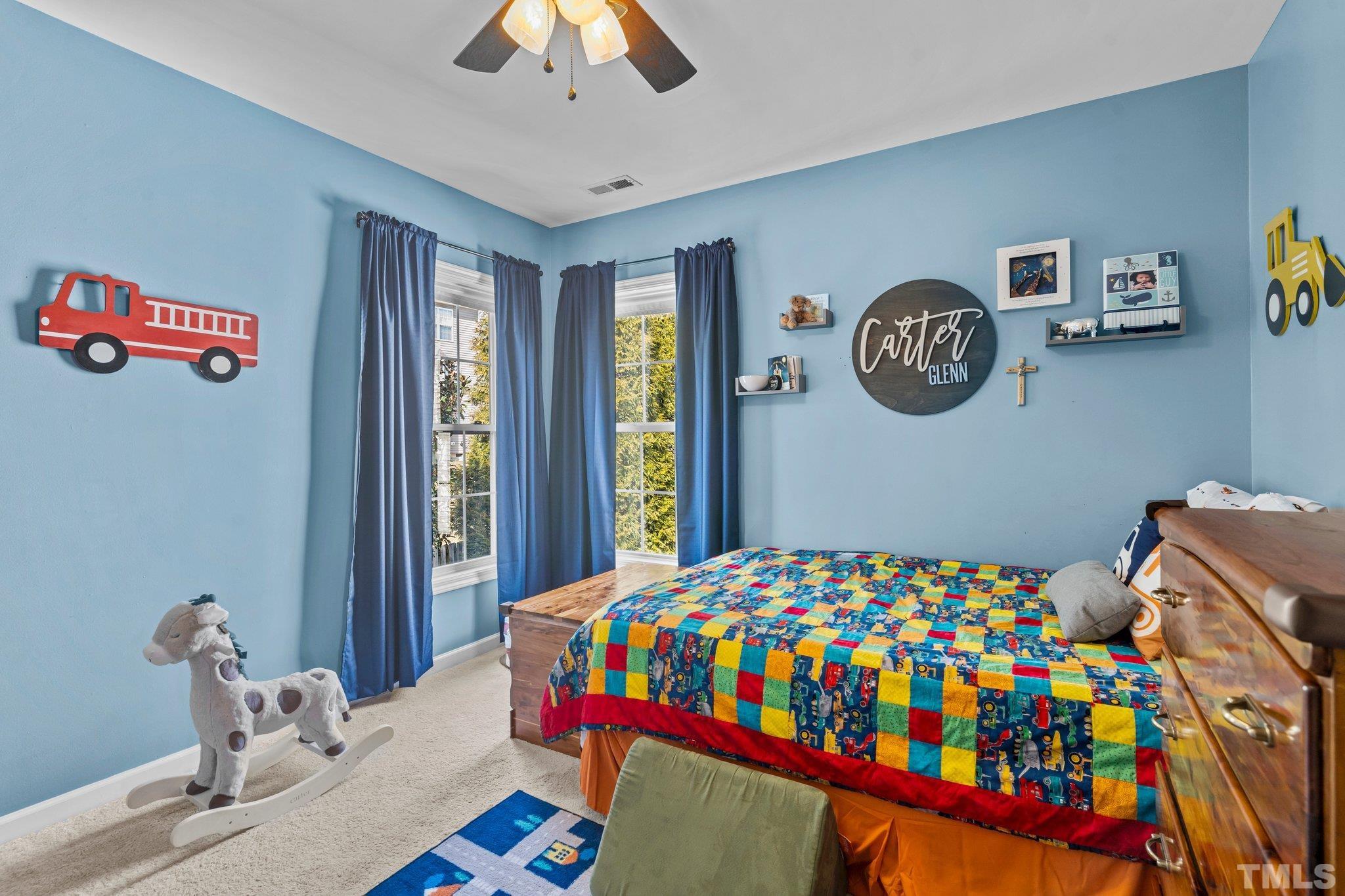 2359 Spruce Shadows Lane Raleigh, NC 27614 - Photo 21 of 34 a bedroom with a bed and a table in it