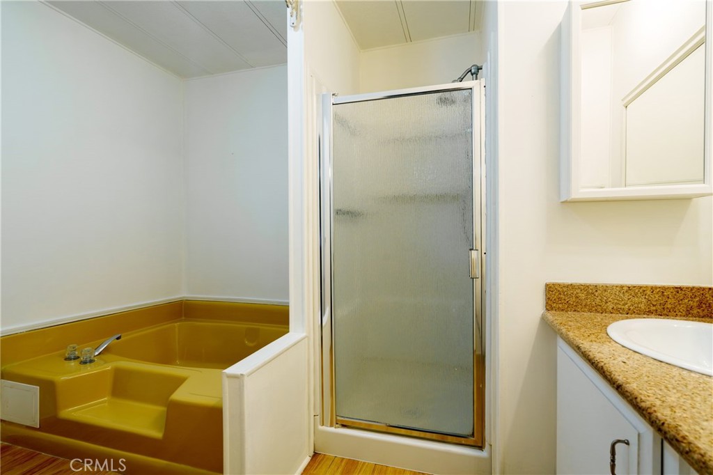 4000 Pierce Street, Unit 72 Riverside, CA 92505 - Photo 15 of 20 a bathroom with a granite countertop sink and a shower