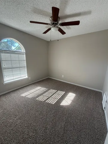 an empty room with a empty space and windows