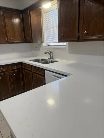 a kitchen with a sink a cabinets and window