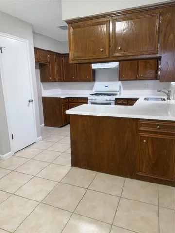 a kitchen with kitchen island cabinets and appliances