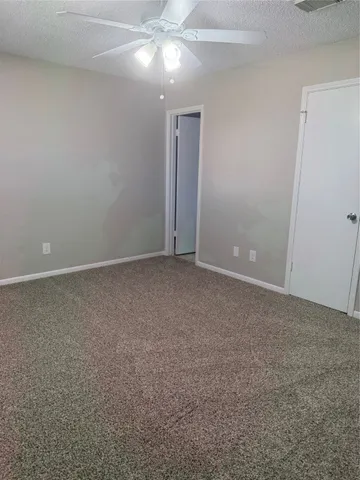 a view of an empty room with a fan