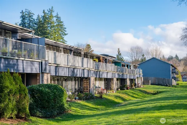 a large building with a big yard and large trees