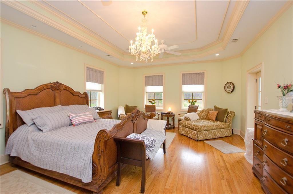1331 Barrows Grove Road Madison, GA 30650 - Photo 14 of 47 a spacious bedroom with a bed and ceiling fan