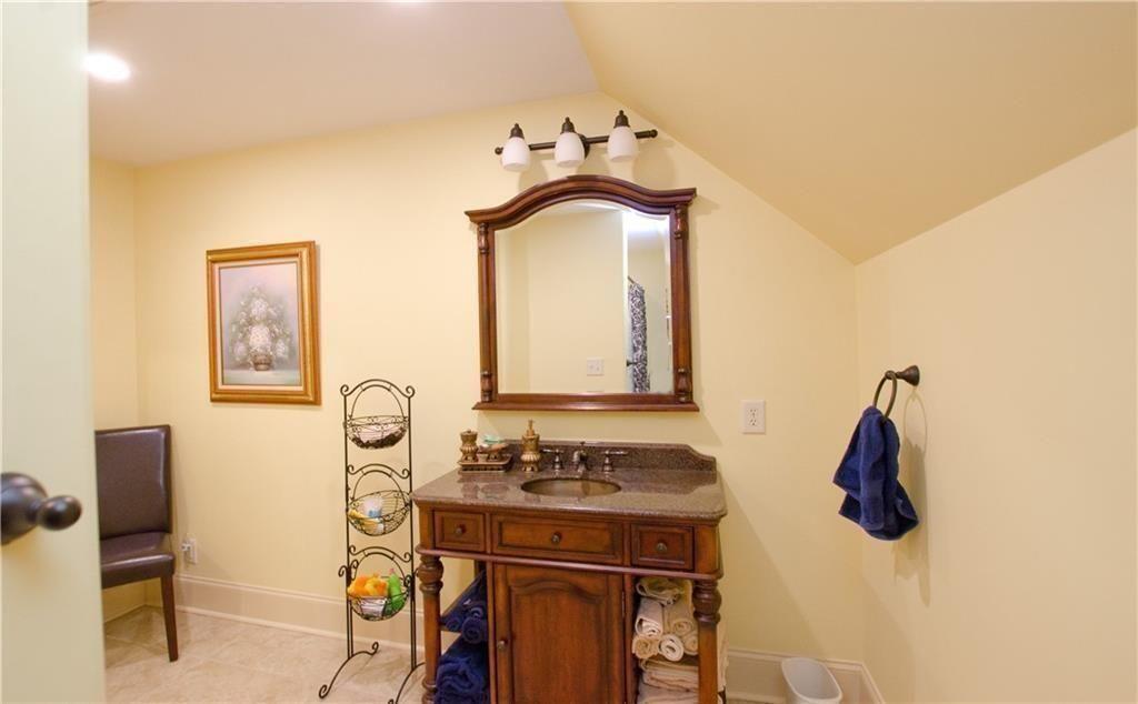 1331 Barrows Grove Road Madison, GA 30650 - Photo 23 of 47 a bathroom with a sink and a mirror