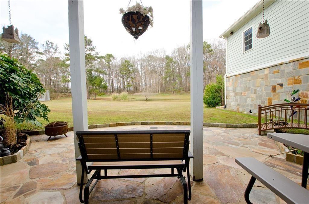 1331 Barrows Grove Road Madison, GA 30650 - Photo 39 of 47 a view of a patio with a table chairs and a patio