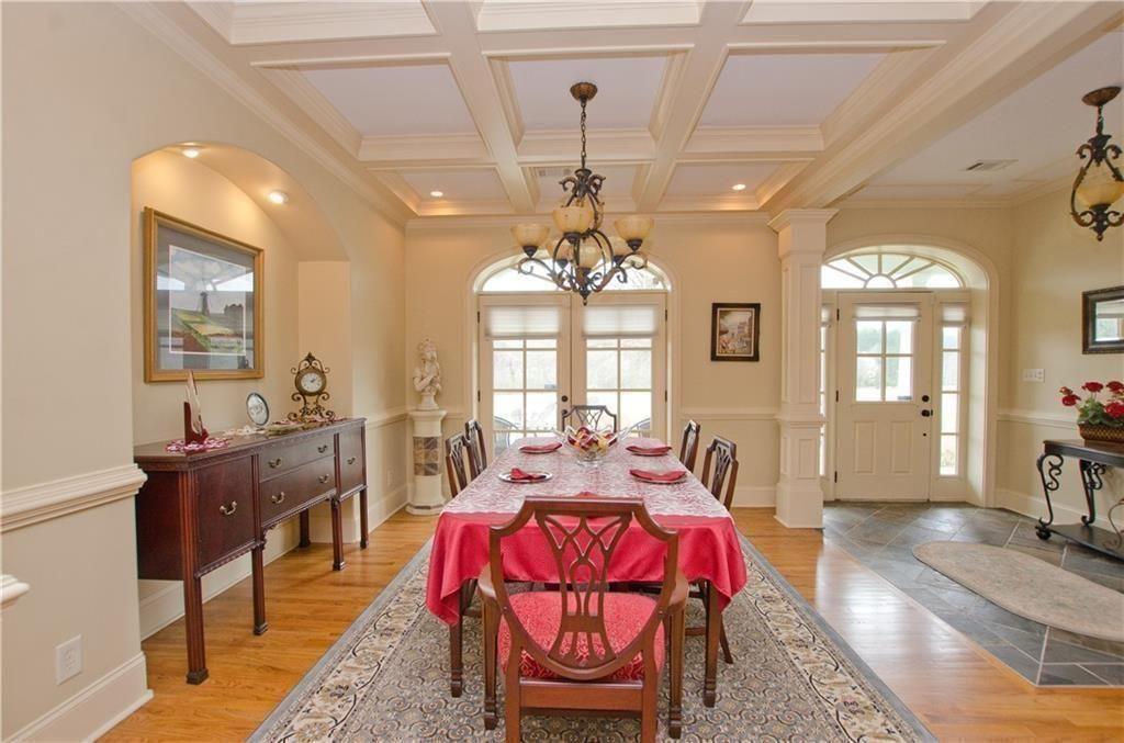 1331 Barrows Grove Road Madison, GA 30650 - Photo 5 of 47 a living room with furniture a chandelier and a dining table