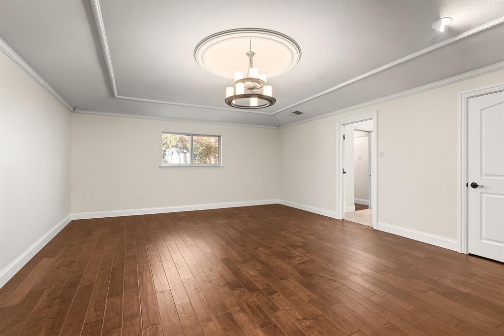 9552 Timberleaf Drive Dallas, TX 75243 - Photo 13 of 38 a view of an empty room with wooden floor and a window