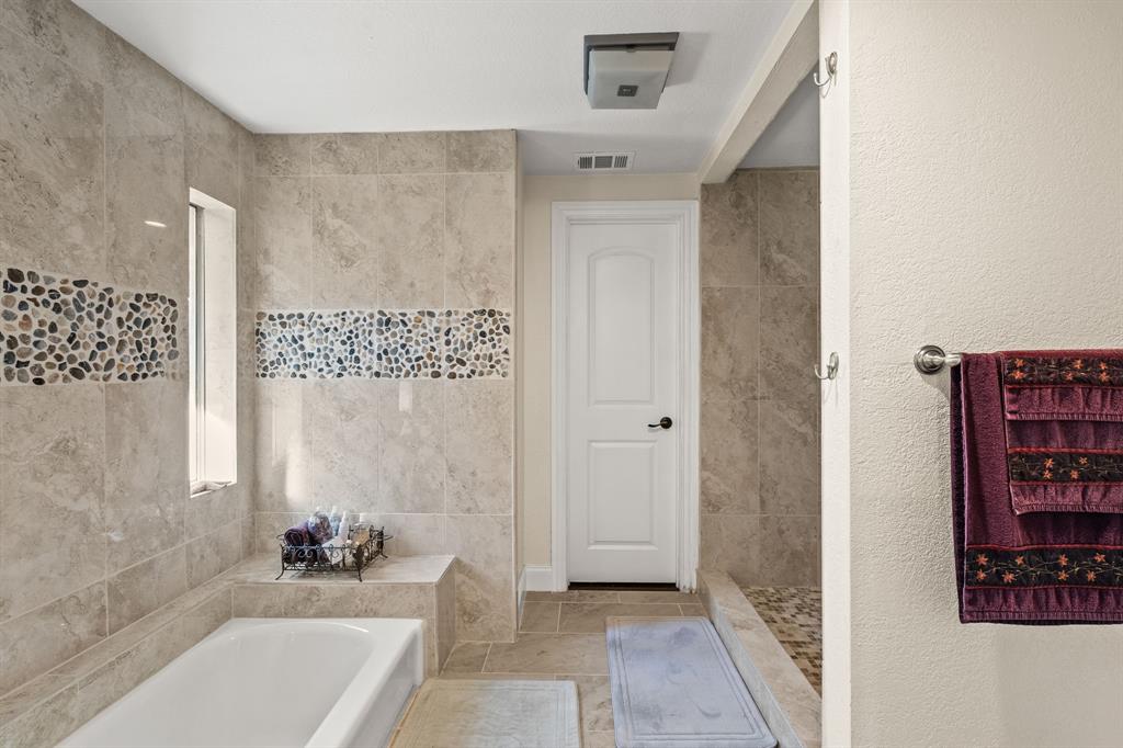 9552 Timberleaf Drive Dallas, TX 75243 - Photo 20 of 38 a bathroom with a bathtub and a shower