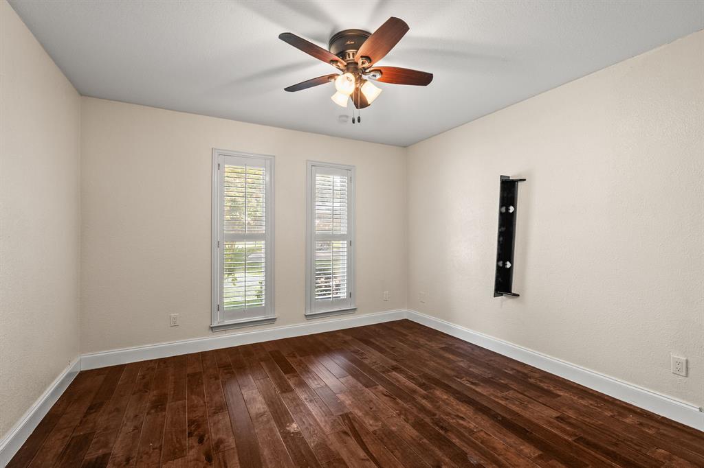 9552 Timberleaf Drive Dallas, TX 75243 - Photo 22 of 38 an empty room with window and wooden floor