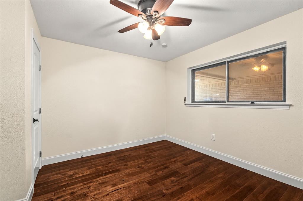 9552 Timberleaf Drive Dallas, TX 75243 - Photo 23 of 38 a view of a room with wooden floor and a window