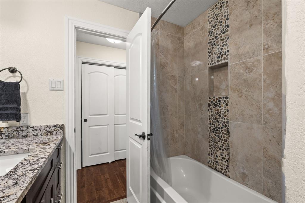 9552 Timberleaf Drive Dallas, TX 75243 - Photo 24 of 38 a bathroom with a granite countertop sink a toilet and shower