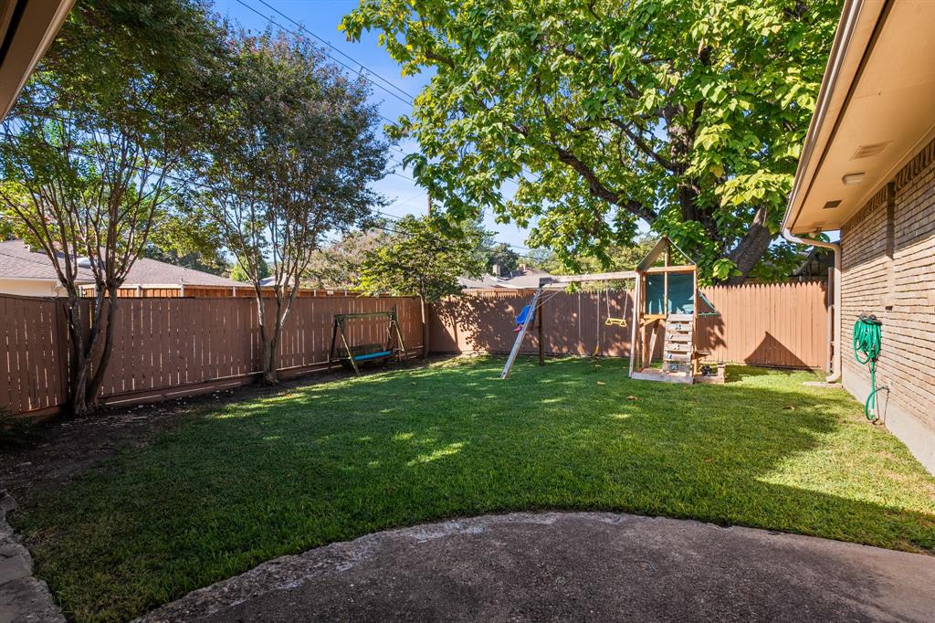 9552 Timberleaf Drive Dallas, TX 75243 - Photo 28 of 38 a view of backyard with wooden fence and a large tree