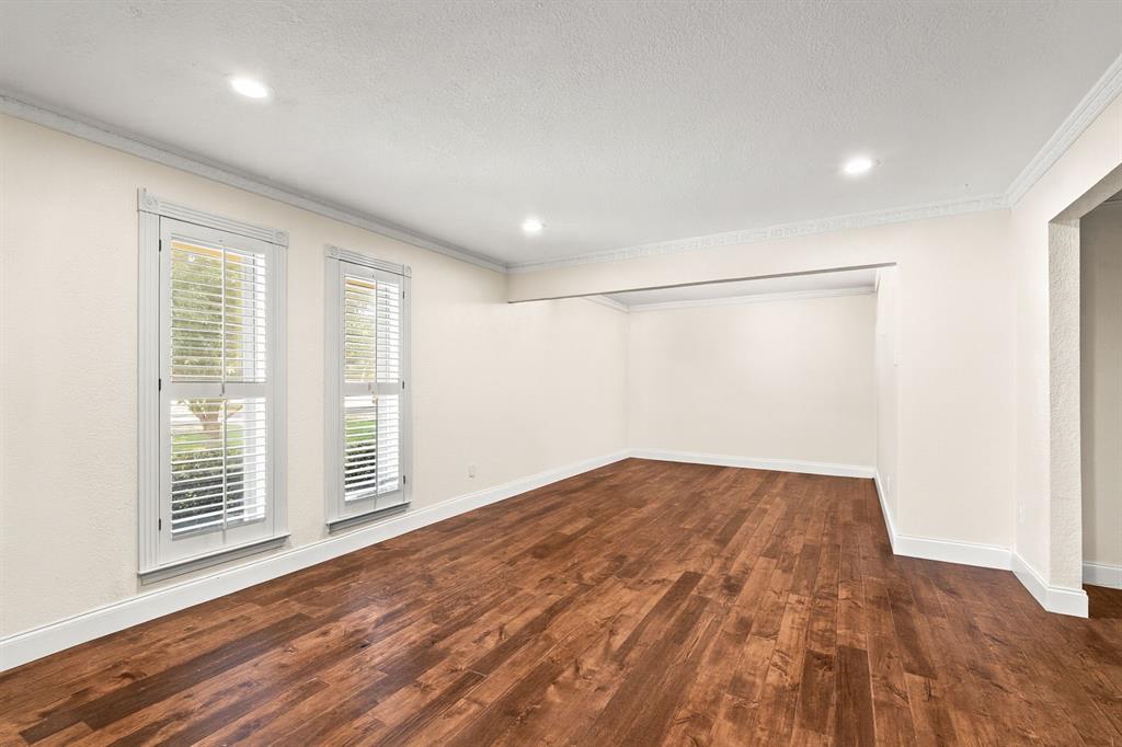 9552 Timberleaf Drive Dallas, TX 75243 - Photo 3 of 38 an empty room with wooden floor and windows
