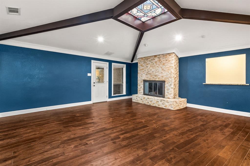 9552 Timberleaf Drive Dallas, TX 75243 - Photo 5 of 38 a view of an empty room with window and wooden floor