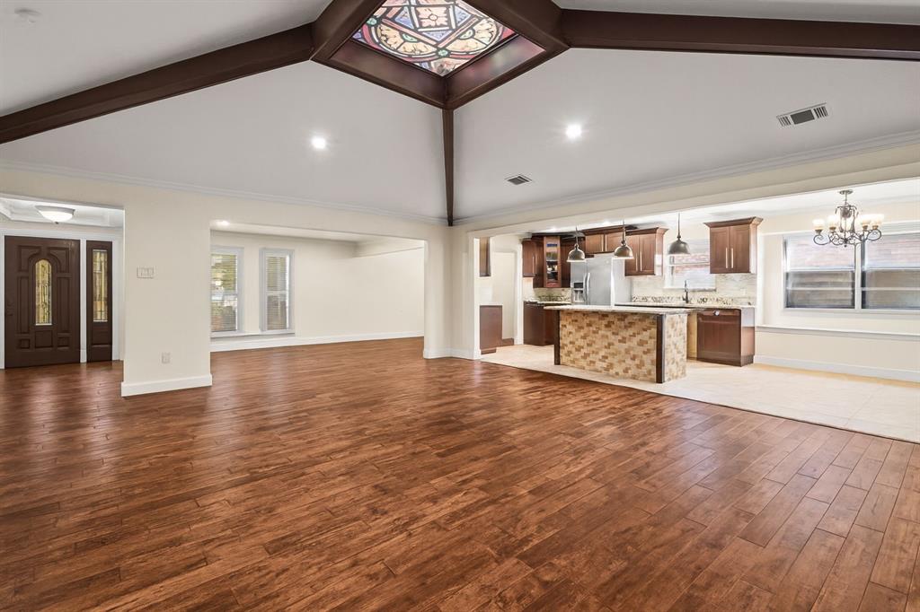 9552 Timberleaf Drive Dallas, TX 75243 - Photo 6 of 38 a view of a kitchen with kitchen island wooden floor and stainless steel appliances