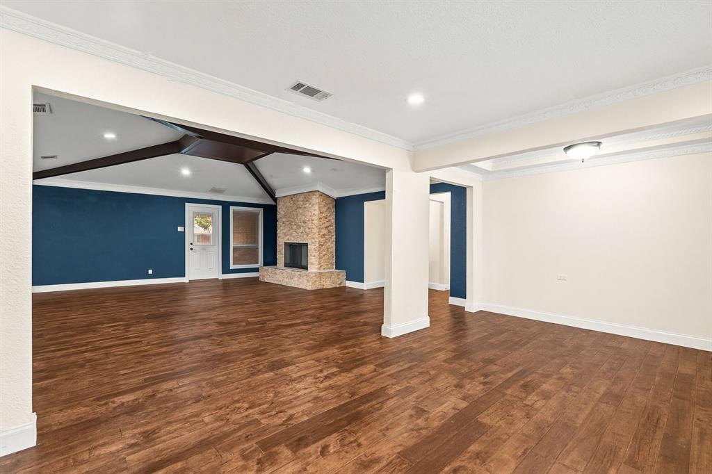 9552 Timberleaf Drive Dallas, TX 75243 - Photo 7 of 38 a view of an empty room with wooden floor and a window