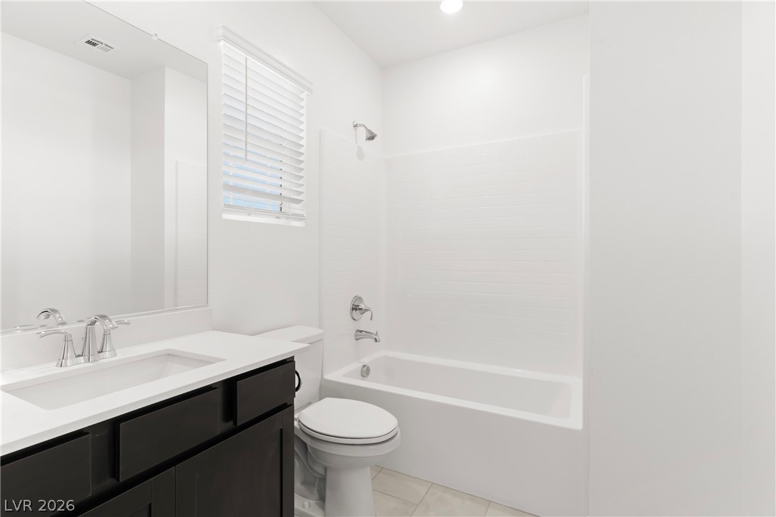 320 Isla Enclave Way Henderson, NV 89011 - Photo 28 of 49 This sleek bathroom features a single vanity, clean lines, and a shower-over-tub combination for refreshing daily routines.