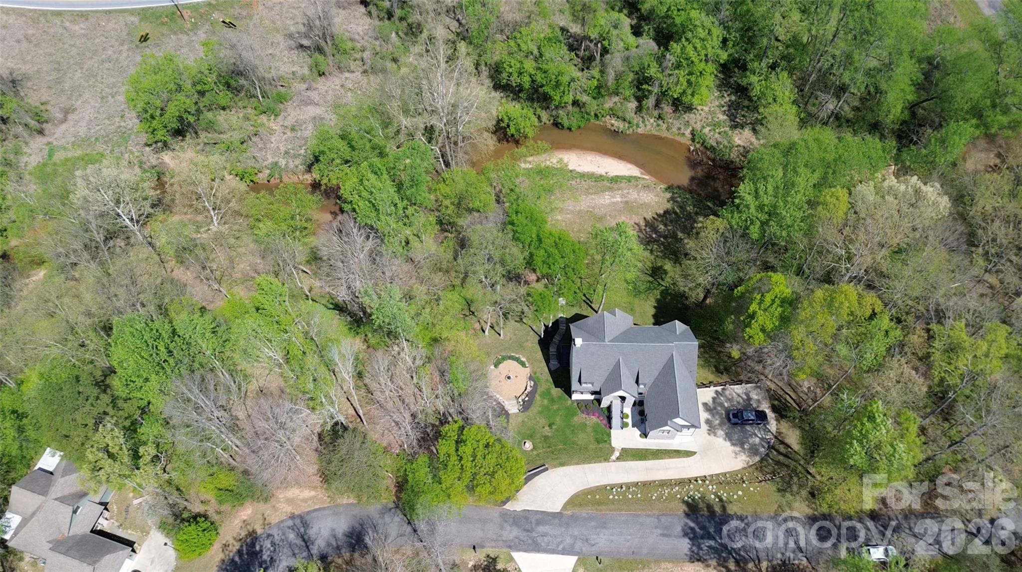 34 West Rambling Creek Drive Tryon, NC 28782 - Photo 3 of 5 an aerial view of a house with a yard and large trees