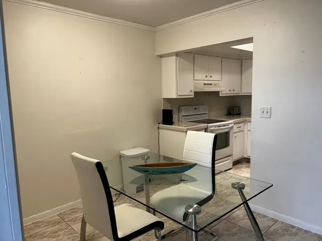 a kitchen with a table and chairs