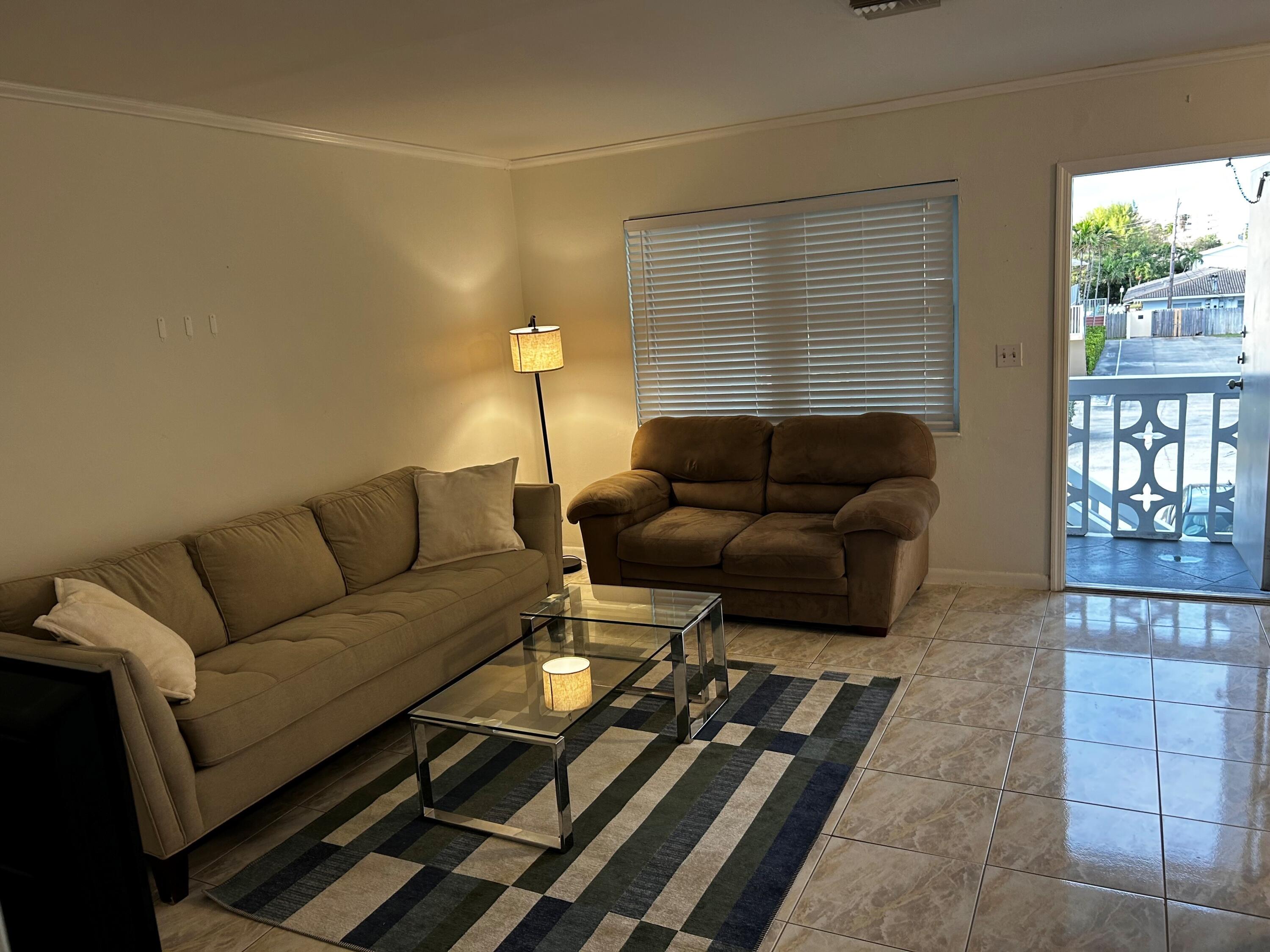 3220 Northeast 10th Street, Unit 15 Pompano Beach, FL 33062 - Photo 6 of 6 a living room with furniture and a window