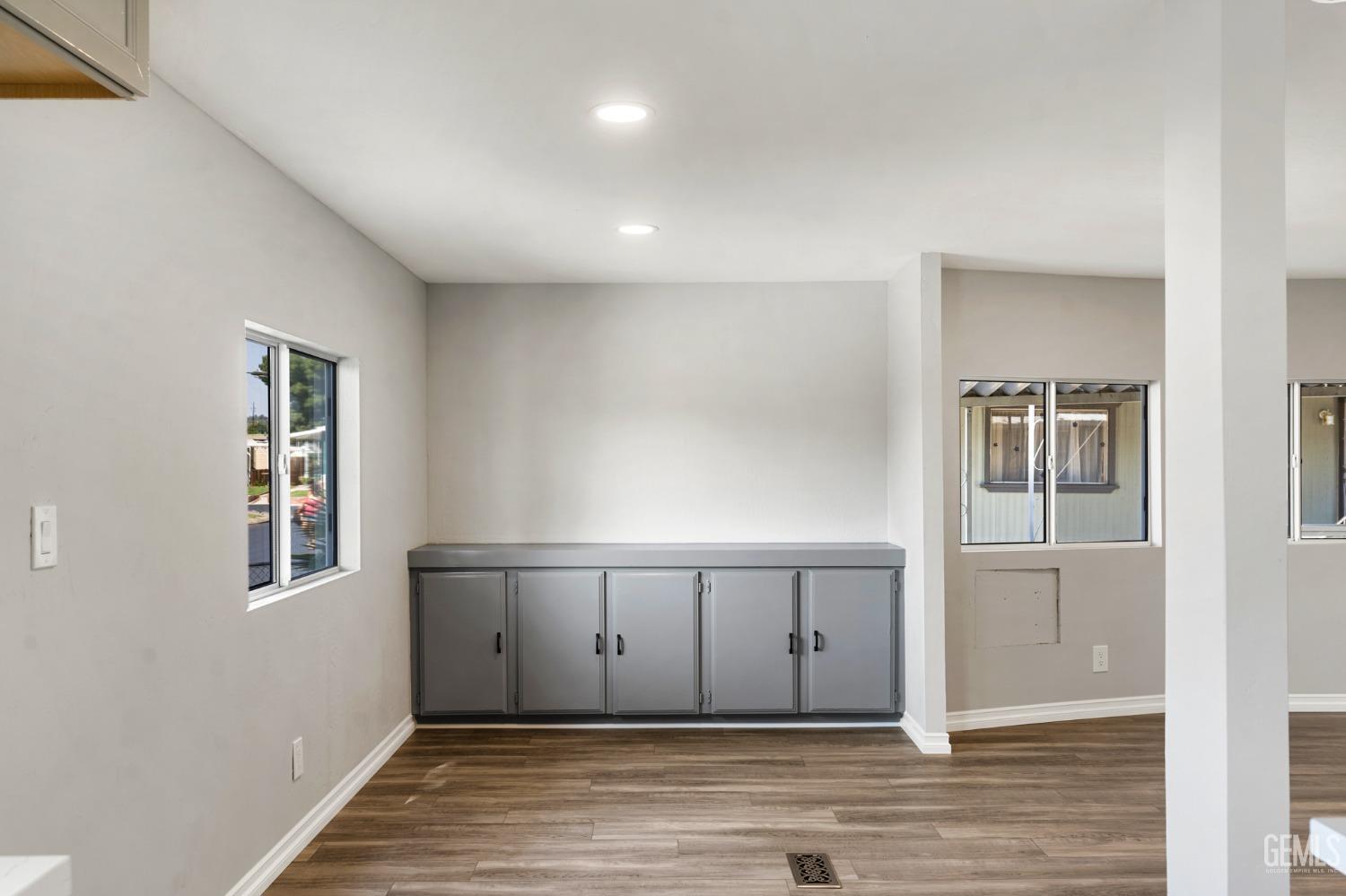 Undisclosed Address Bakersfield, CA 93306 - Photo 12 of 25 an empty room with wooden floor and windows