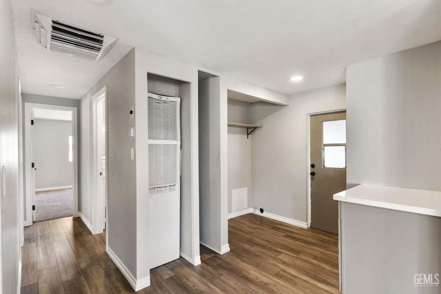 Undisclosed Address Bakersfield, CA 93306 - Photo 14 of 25 a view of a hallway with wooden floor and closet