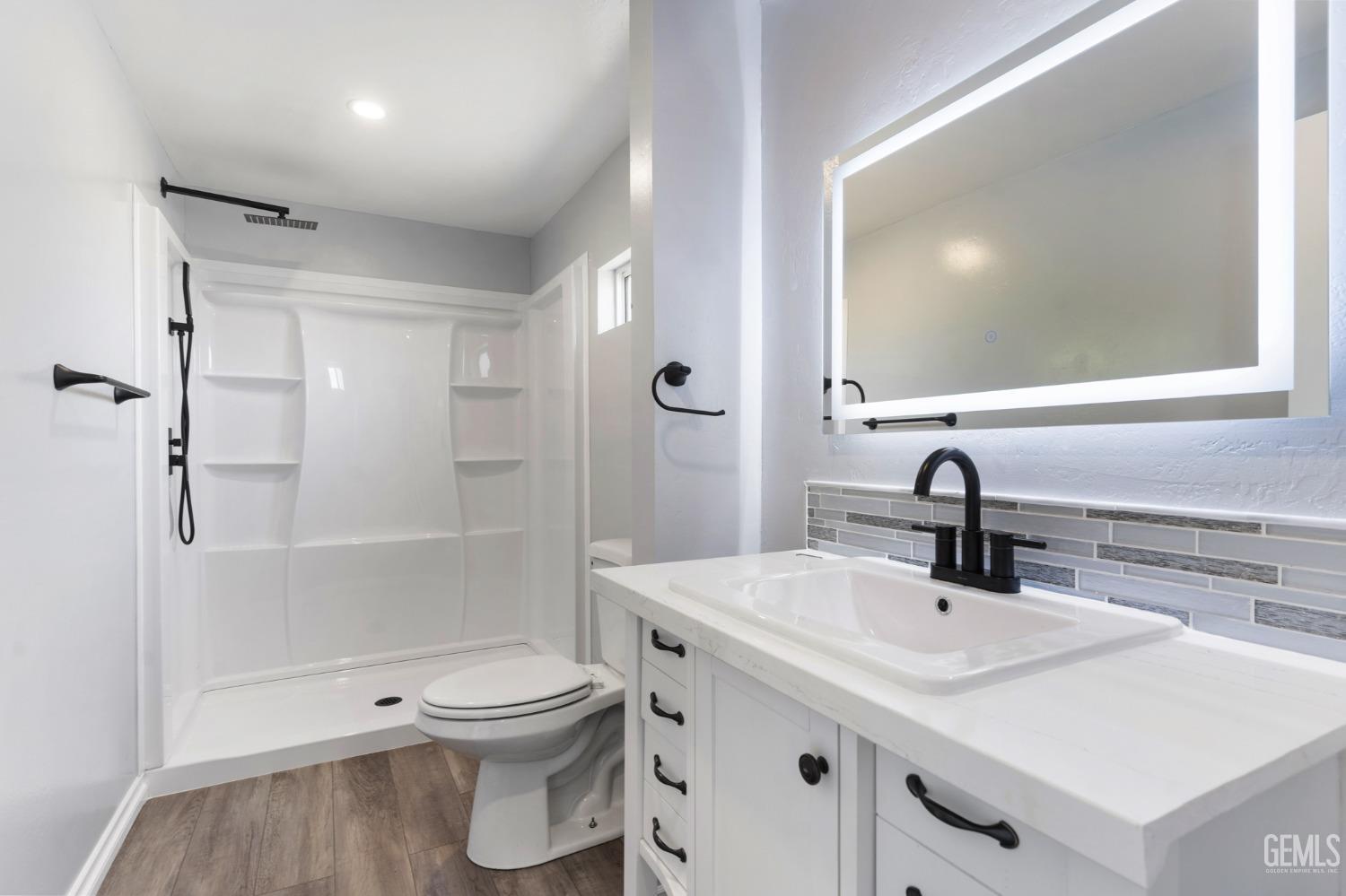 Undisclosed Address Bakersfield, CA 93306 - Photo 15 of 25 a bathroom with a sink a toilet and shower