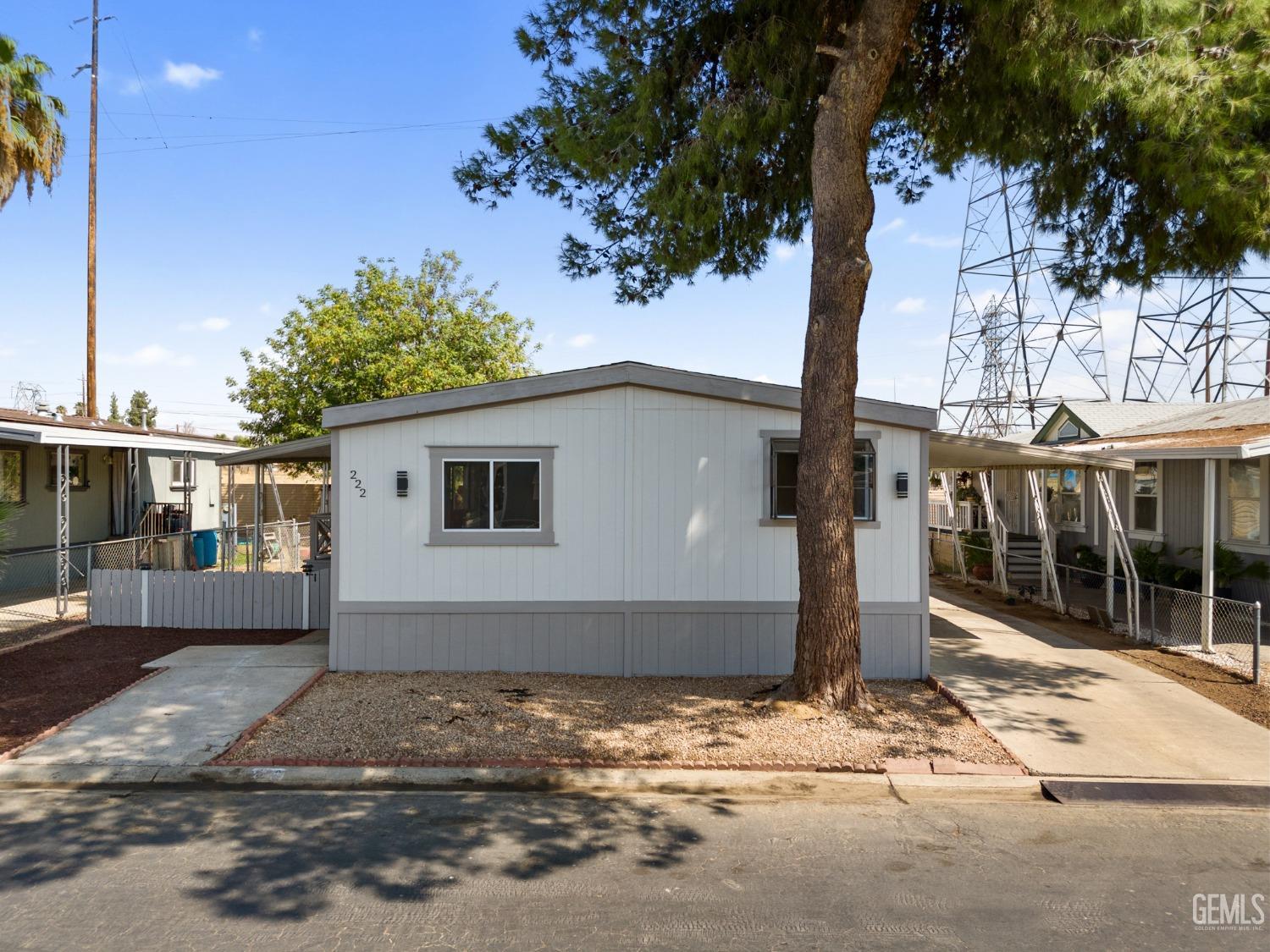 Undisclosed Address Bakersfield, CA 93306 - Photo 2 of 25 a front view of a house with a yard and garage
