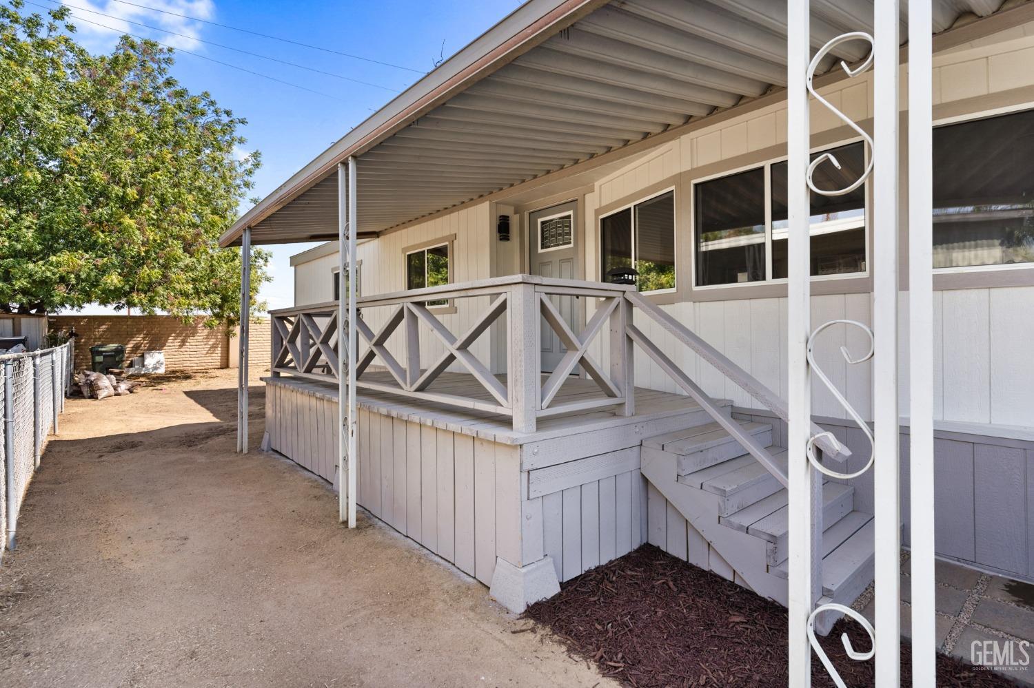 Undisclosed Address Bakersfield, CA 93306 - Photo 3 of 25 a view of a house with a small yard and wooden fence