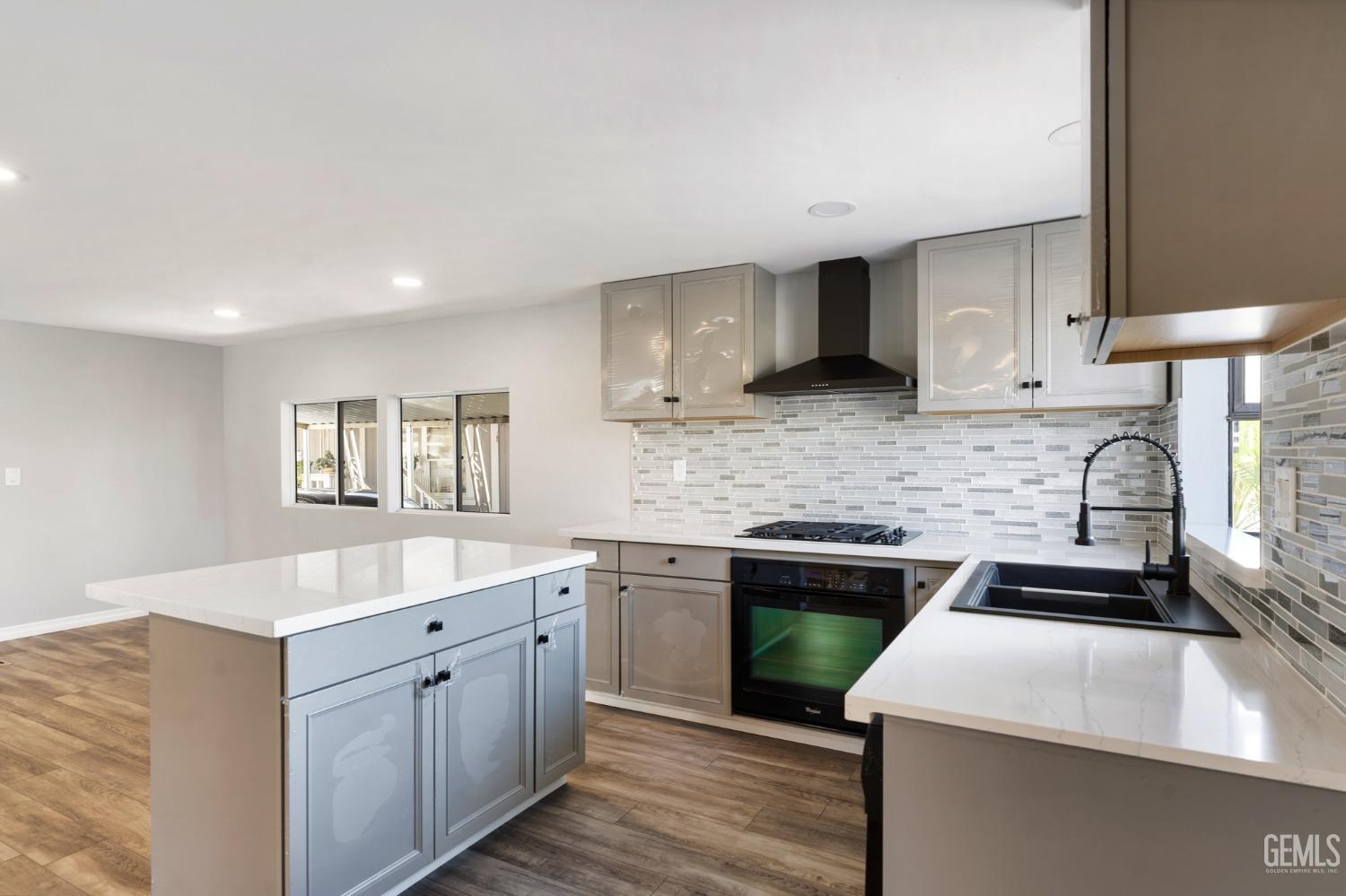 Undisclosed Address Bakersfield, CA 93306 - Photo 5 of 25 a kitchen with a sink stove and cabinets