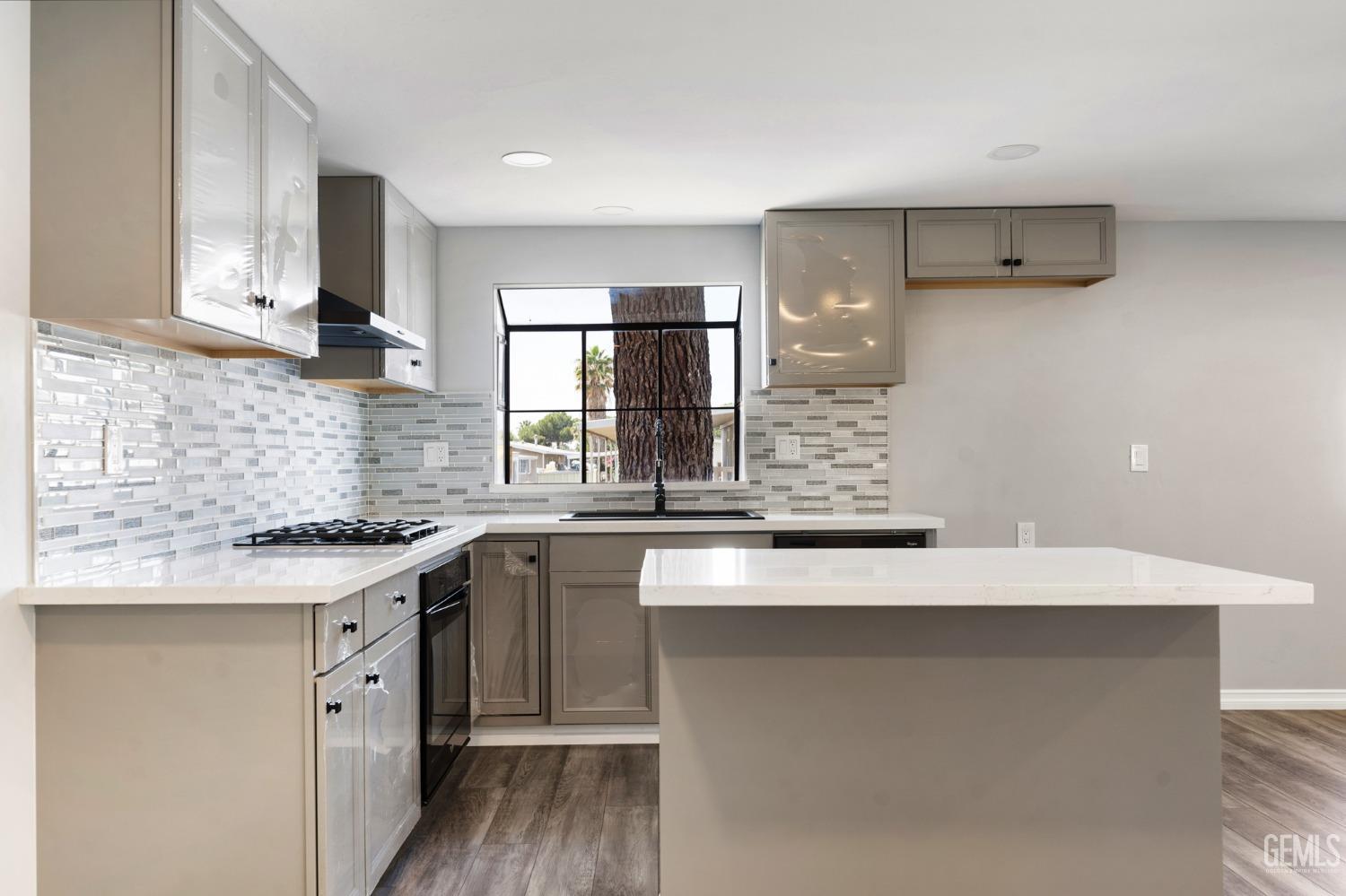 Undisclosed Address Bakersfield, CA 93306 - Photo 6 of 25 a kitchen with a sink and cabinets
