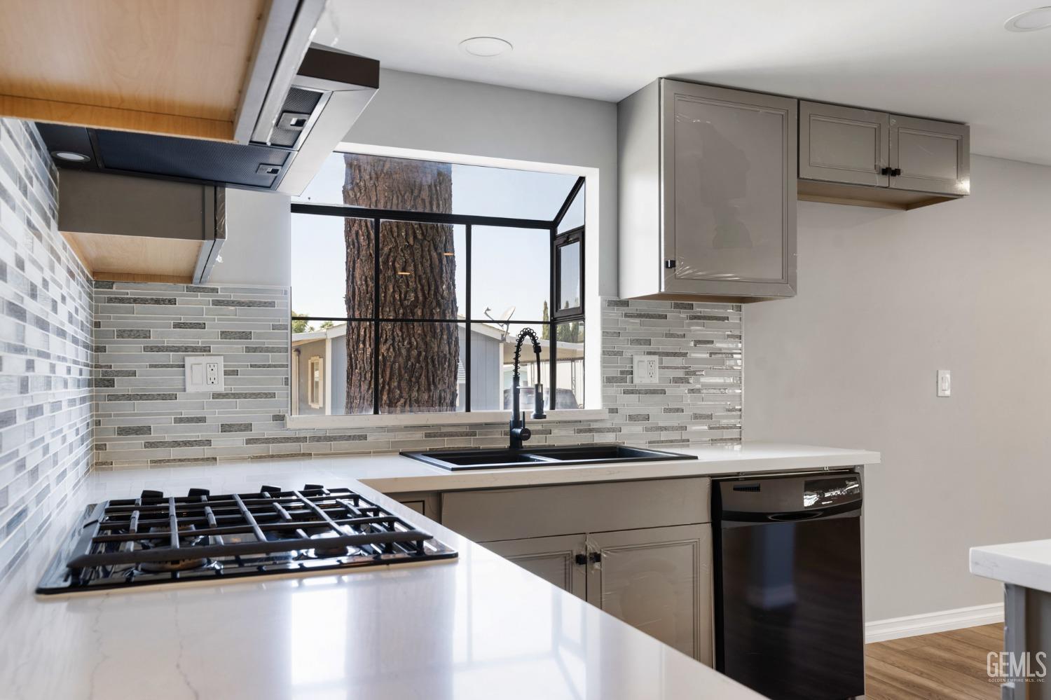 Undisclosed Address Bakersfield, CA 93306 - Photo 7 of 25 a kitchen with granite countertop a sink stove and refrigerator