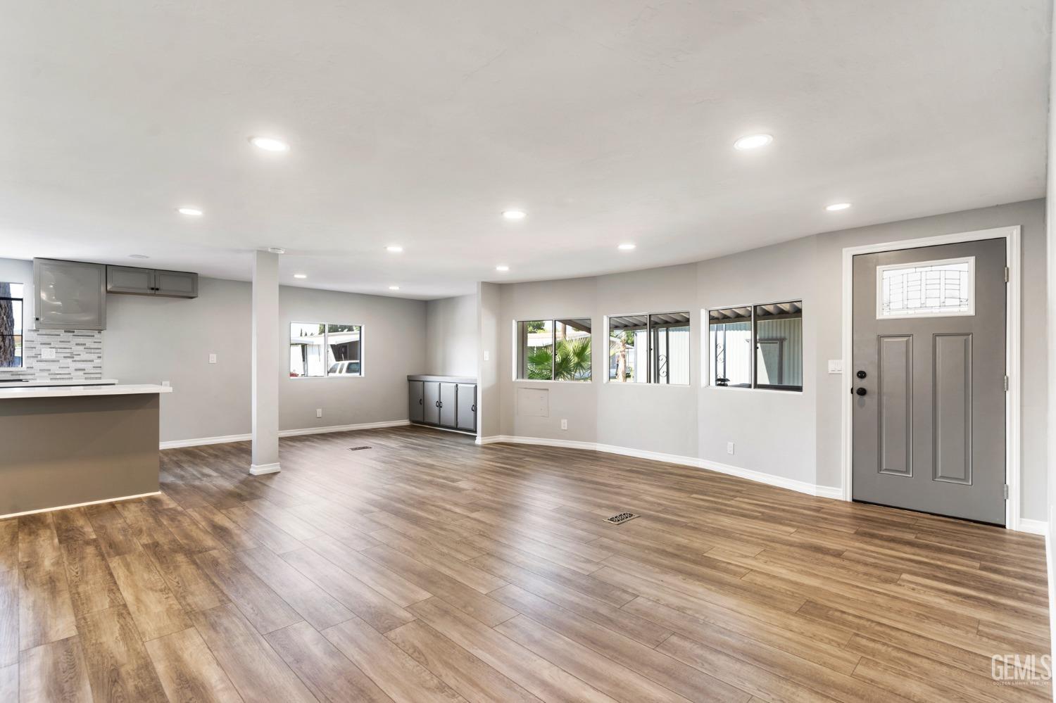Undisclosed Address Bakersfield, CA 93306 - Photo 9 of 25 an empty room with wooden floor and windows