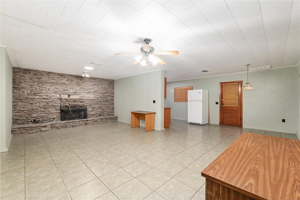 4367 Highway 301 Bushnell, FL 33513 - Photo 11 of 44 an empty room with chandelier fan and windows
