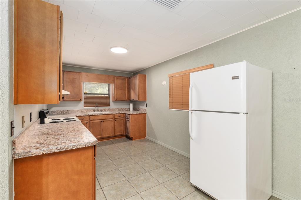 4367 Highway 301 Bushnell, FL 33513 - Photo 14 of 44 a kitchen with a refrigerator a sink and a stove