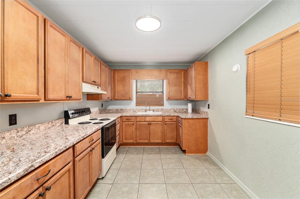 4367 Highway 301 Bushnell, FL 33513 - Photo 15 of 44 a kitchen with a sink stove and cabinets