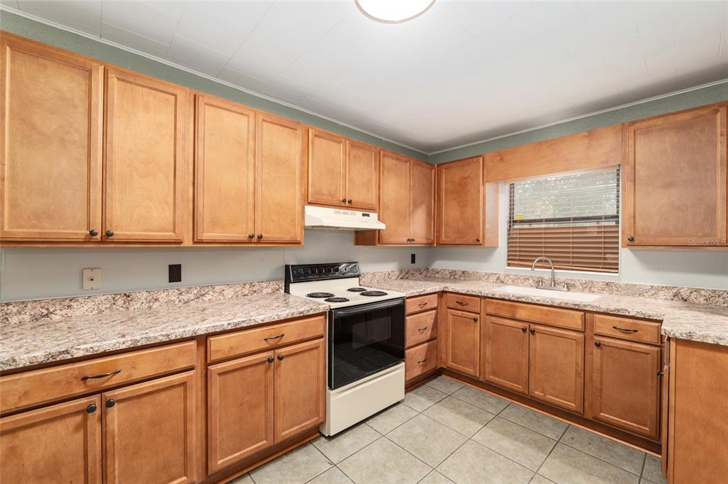 4367 Highway 301 Bushnell, FL 33513 - Photo 16 of 44 a kitchen with a sink stove top oven and cabinets