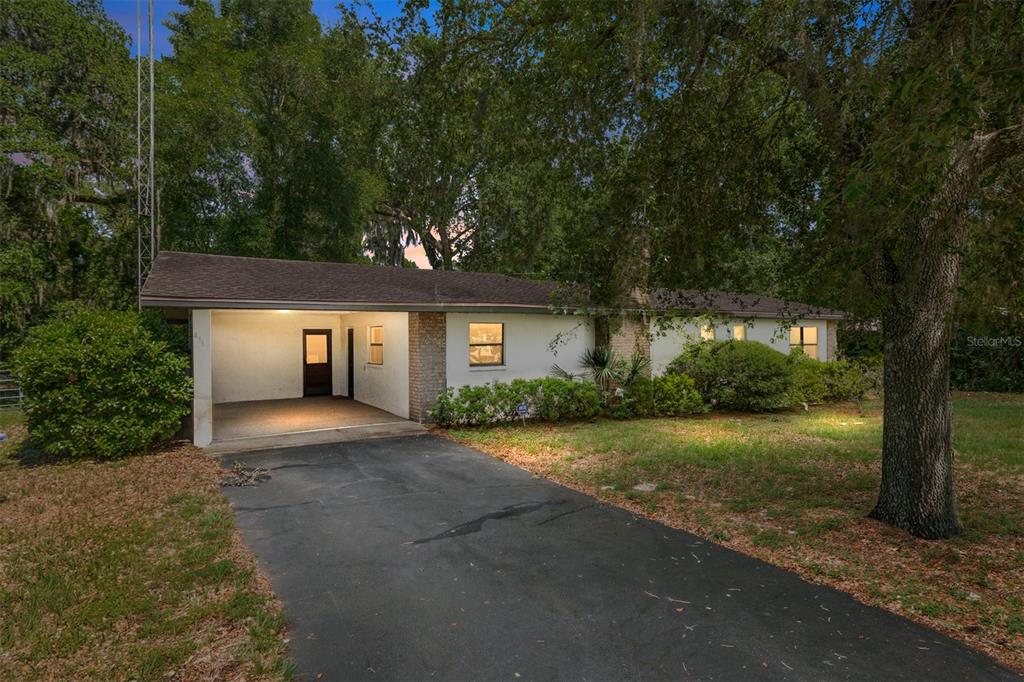 4367 Highway 301 Bushnell, FL 33513 - Photo 2 of 44 front view of a house with a yard and potted plants