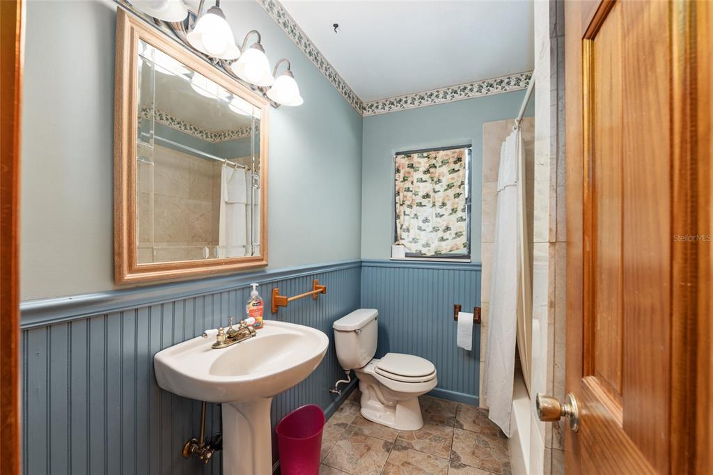 4367 Highway 301 Bushnell, FL 33513 - Photo 27 of 44 a bathroom with a sink a mirror and a toilet