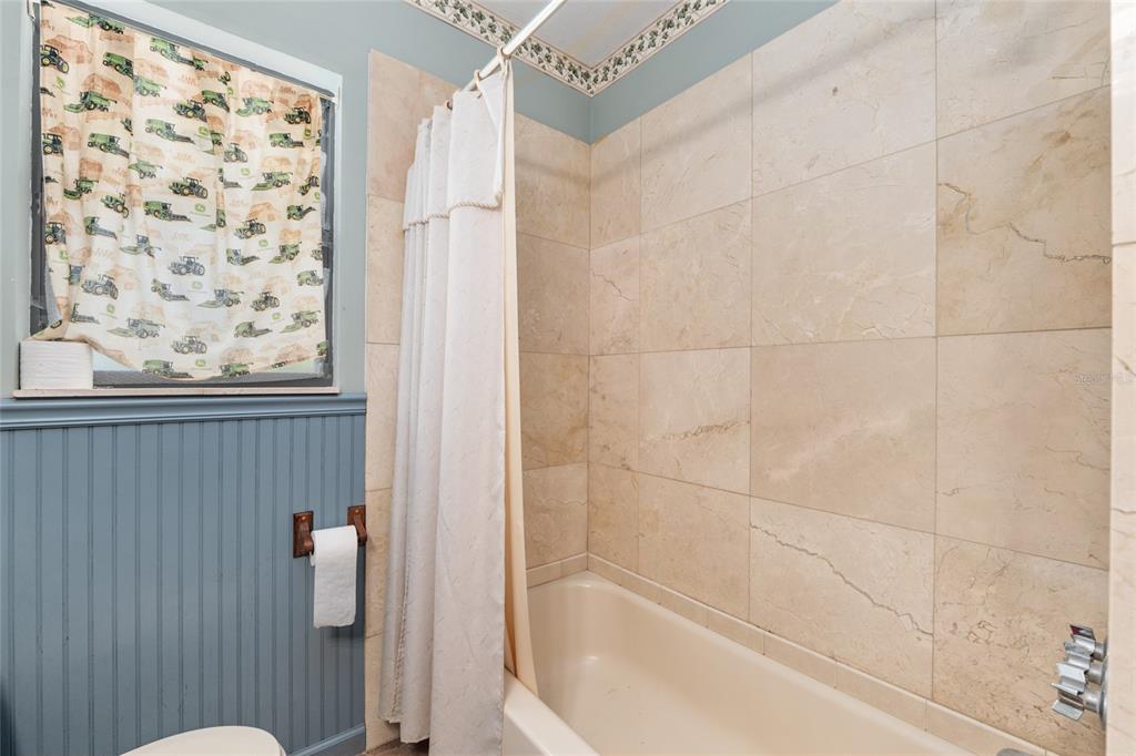 4367 Highway 301 Bushnell, FL 33513 - Photo 28 of 44 a bathroom with a bathtub and shower