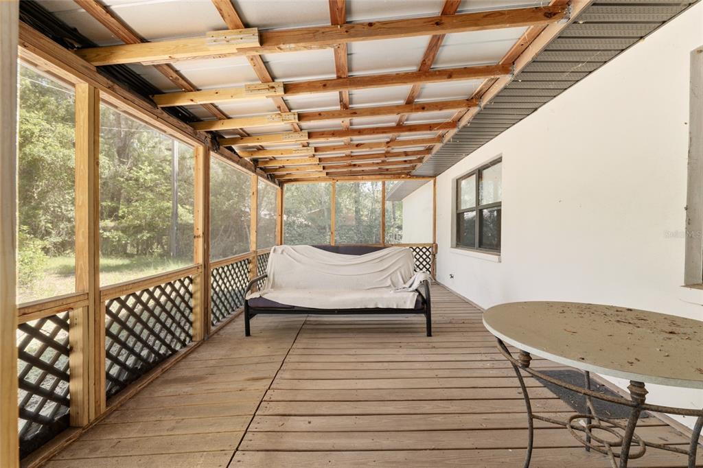 4367 Highway 301 Bushnell, FL 33513 - Photo 32 of 44 a bedroom with a bed and wooden floor