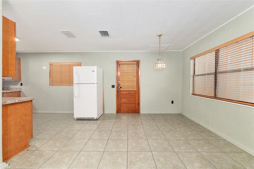 4367 Highway 301 Bushnell, FL 33513 - Photo 7 of 44 a view of a kitchen with a refrigerator cabinet cabinet and a windows