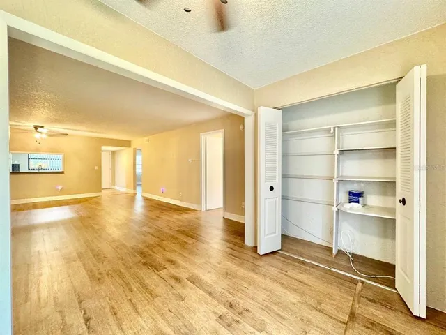 a view of a room with wooden floor