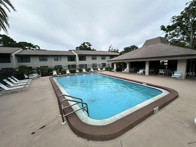 a view of a patio with swimming pool table and chairs